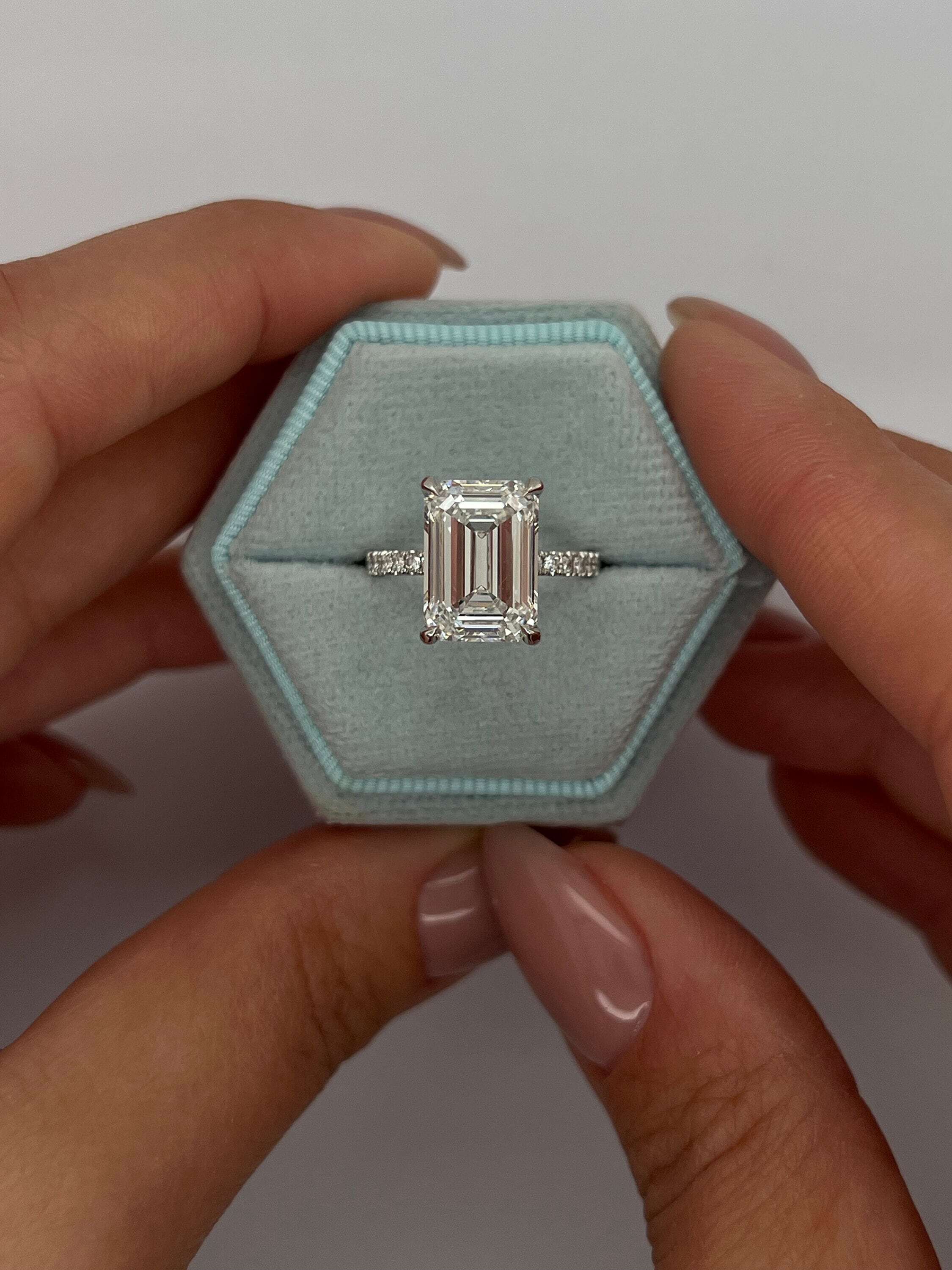 5.3 Carat Emerald Cut Diamond Solitaire Hidden Halo Engagement Ring, Side Round Diamonds