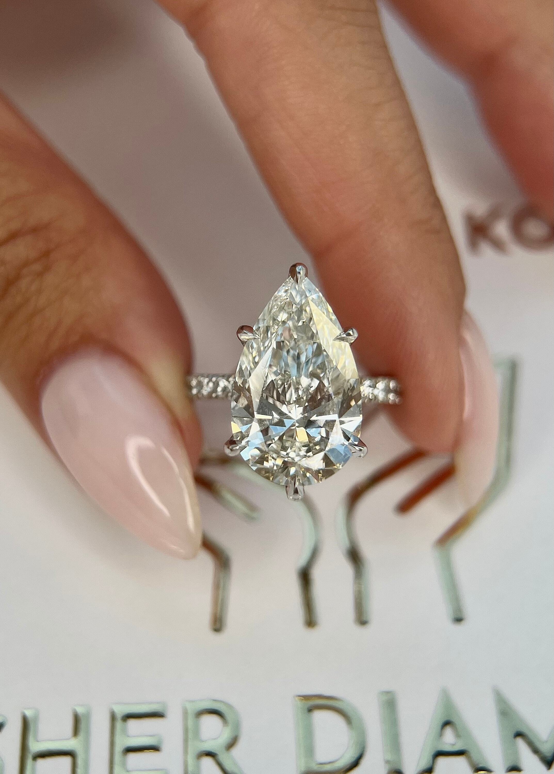 7.5 Carat Pear Cut Hidden Halo Diamond Engagement Ring with Pavé Diamonds