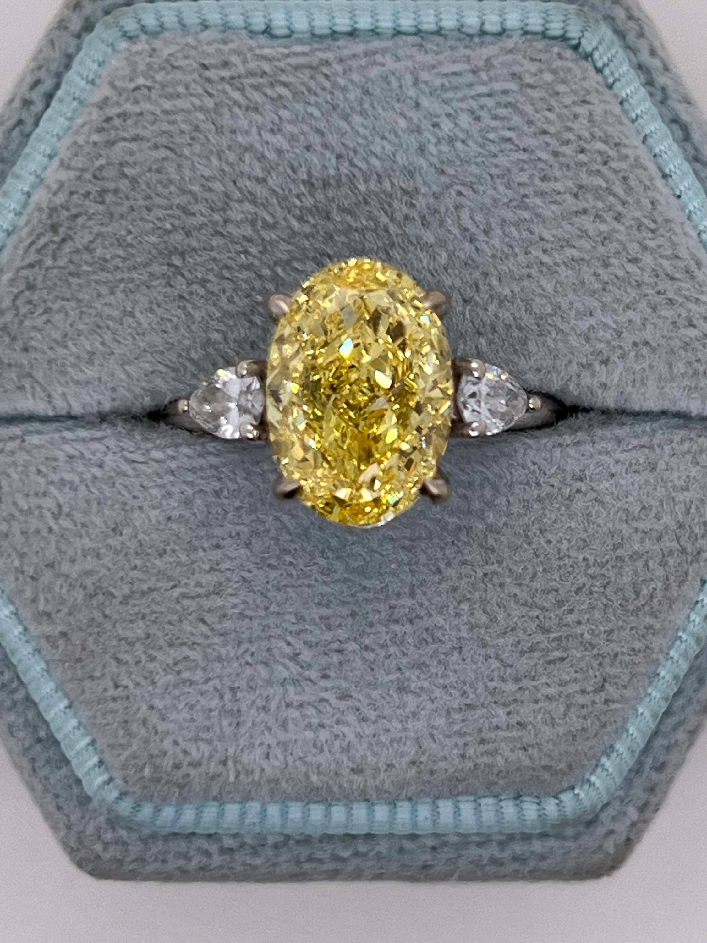 4 Carat Fancy Vivid Yellow Oval Cut Diamond Three Stone Engagement Ring Side Pears
