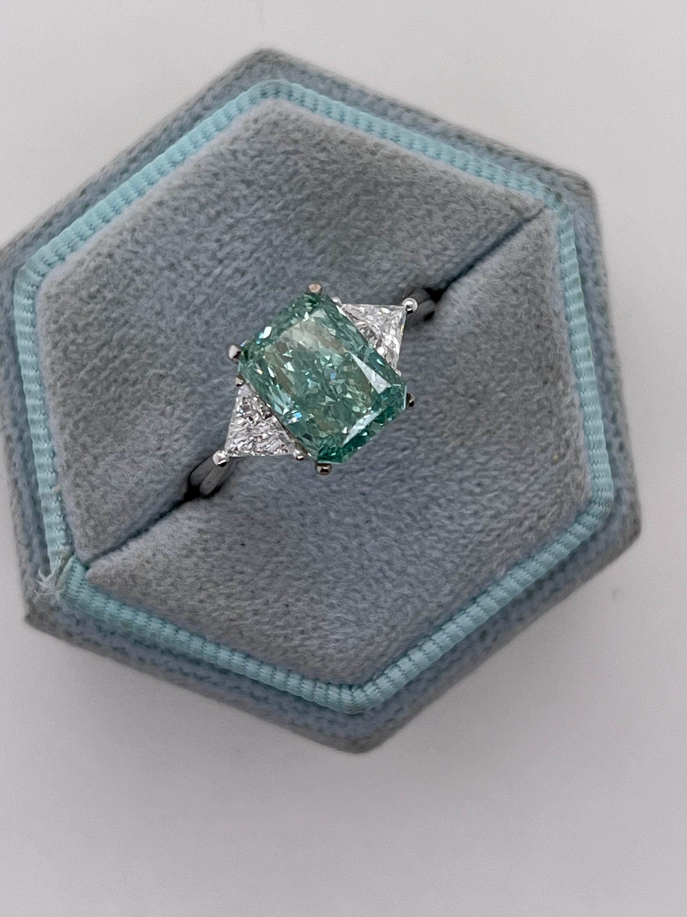 3.5 Carat Fancy Vivid Green Radiant Cut Diamond Three Stone Engagement Ring Side Trillions
