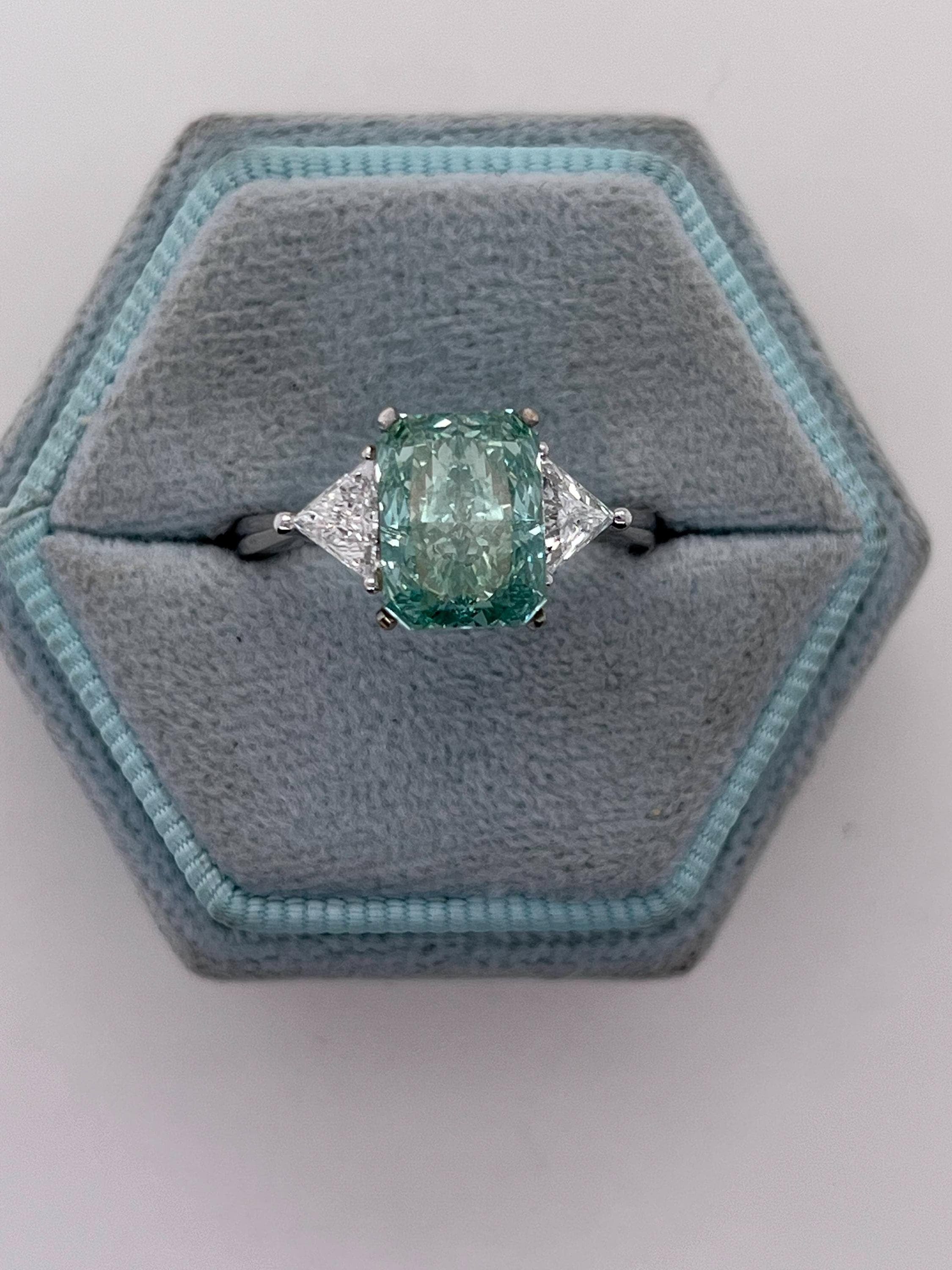 3.5 Carat Fancy Vivid Green Radiant Cut Diamond Three Stone Engagement Ring Side Trillions