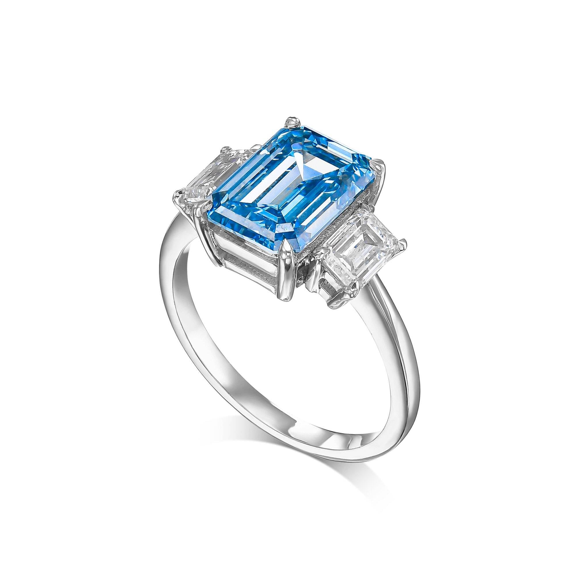 6 Carat Fancy Vivid Blue VVS2 Clarity Emerald Cut Three Stone Diamond Engagement Ring