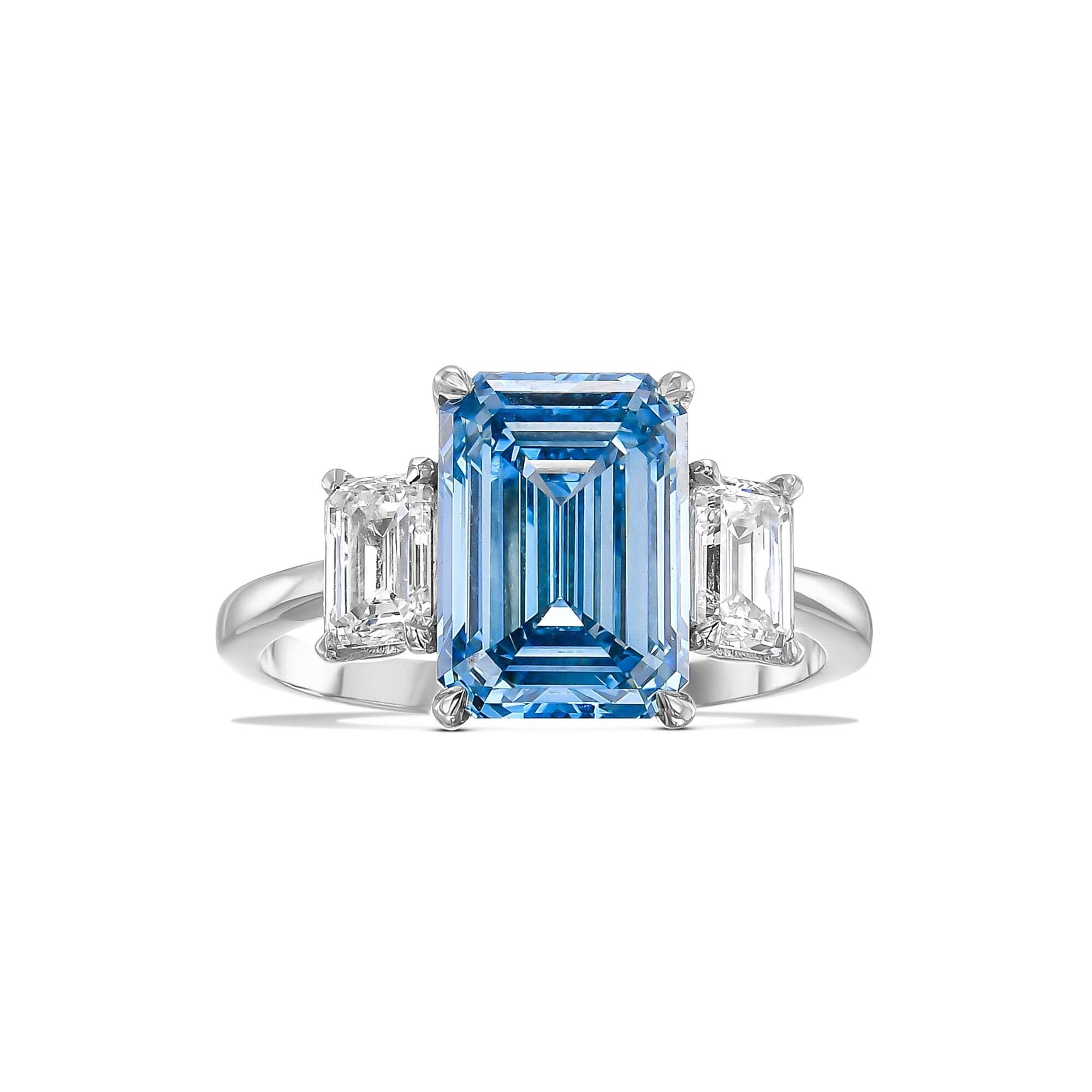 6 Carat Fancy Vivid Blue VVS2 Clarity Emerald Cut Three Stone Diamond Engagement Ring